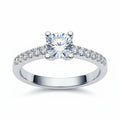 Jade18k Rafaella engagement ring in silver with a central round-cut diamond and smaller stones along the band.