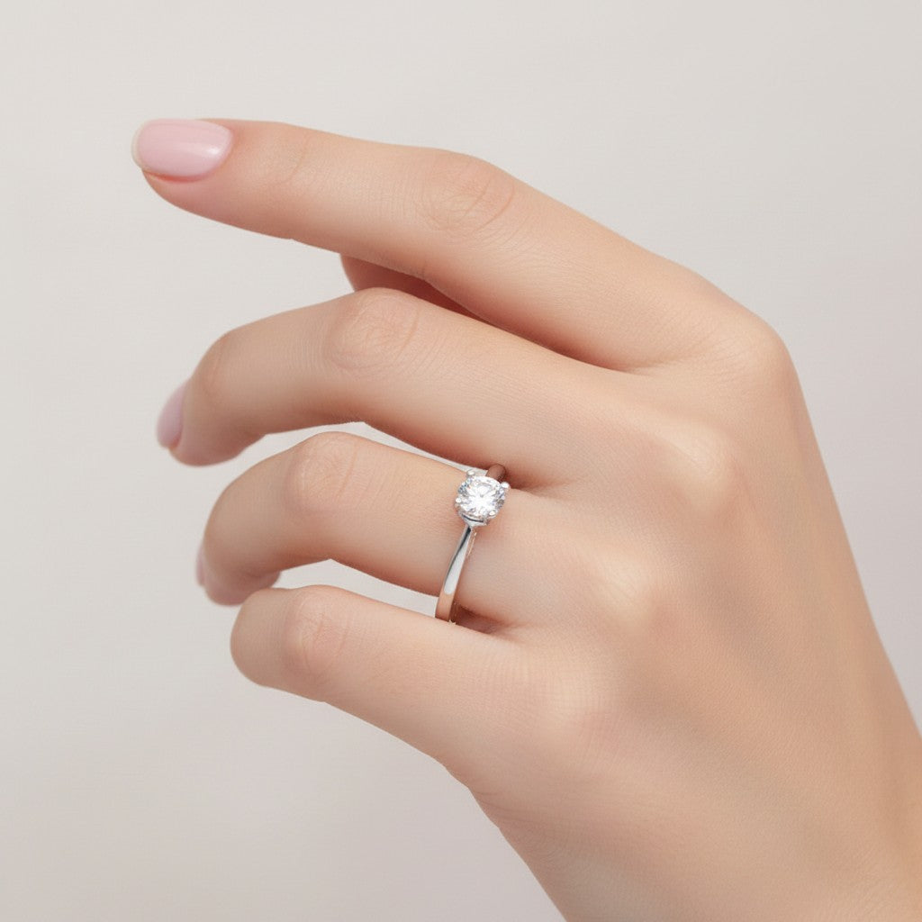 Jade18k sterling silver solitaire ring with cubic zirconia and heart cutouts on band.
