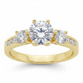 Jade18k yellow gold three-stone engagement ring with round-cut center stone and channel-set accent stones.