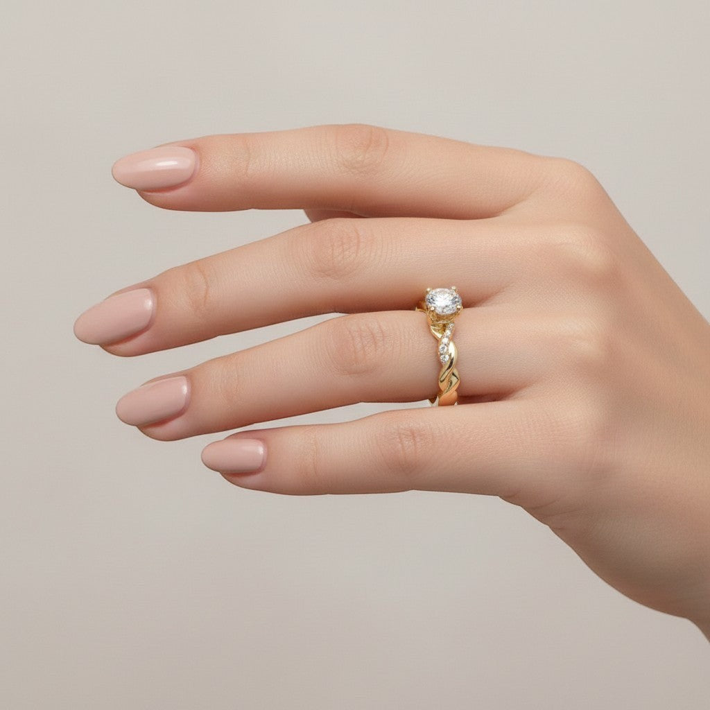 Jade18k yellow gold twisted band solitaire ring with pave accent stones on a woman's hand.