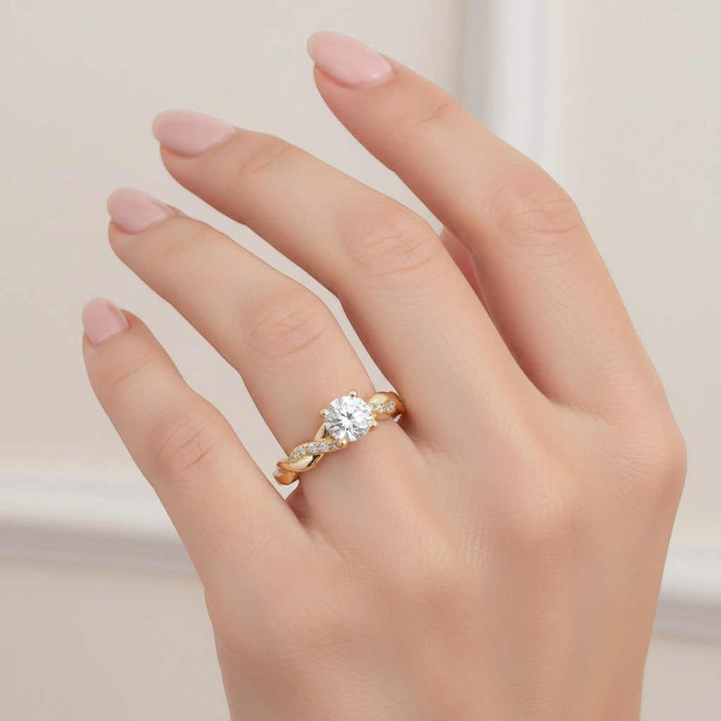 Jade18k yellow gold twisted band solitaire ring with pave accent stones on a woman's hand.