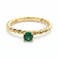 Jade18k 14k yellow gold ring with a twisted band and a round green emerald solitaire.