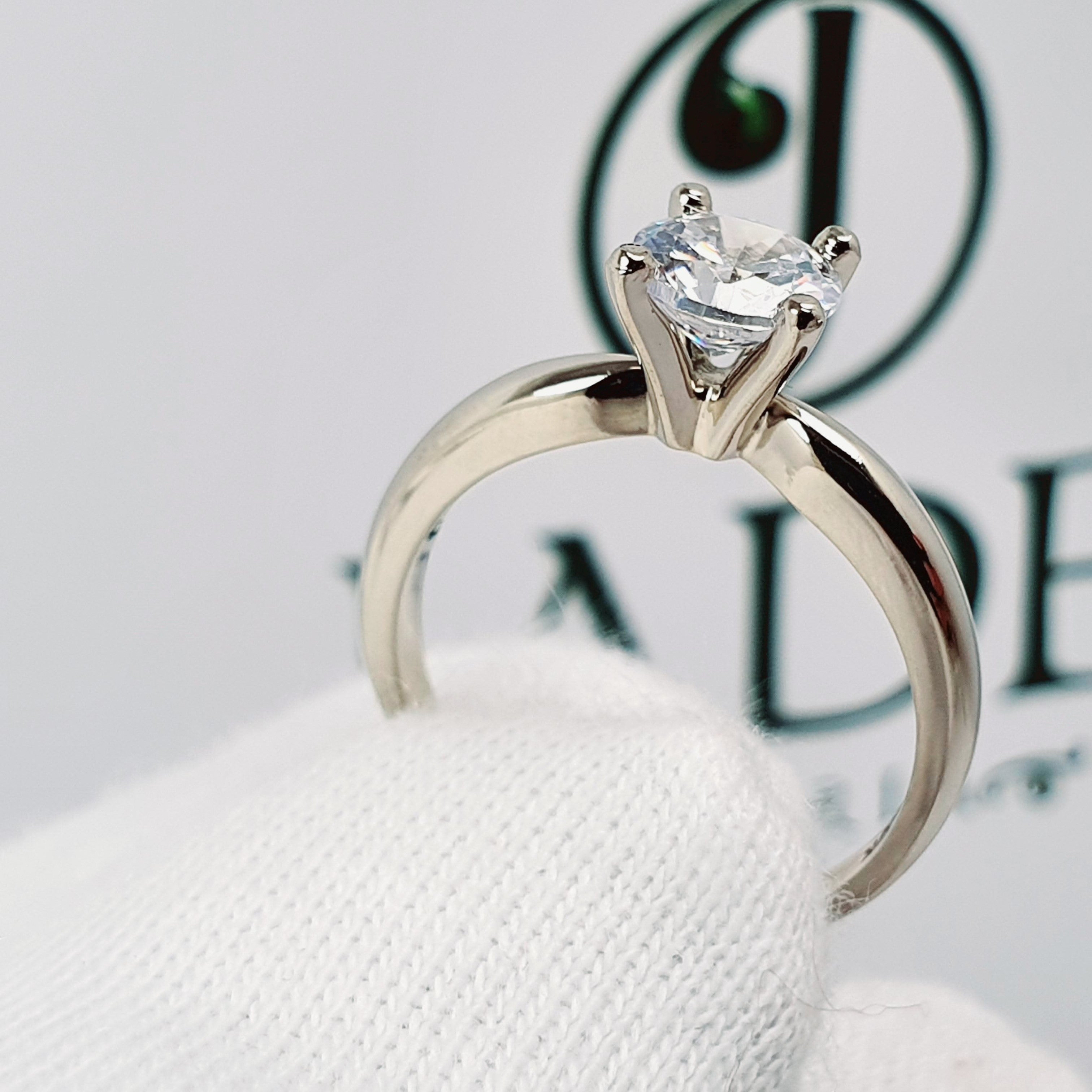 Jade18k 18k white gold solitaire engagement ring with a clear round-cut diamond.