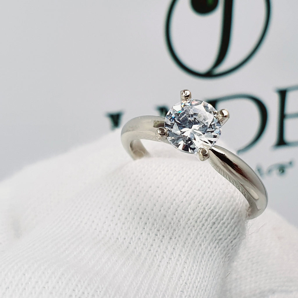 Jade18k 18k white gold solitaire engagement ring with a round brilliant cut diamond.