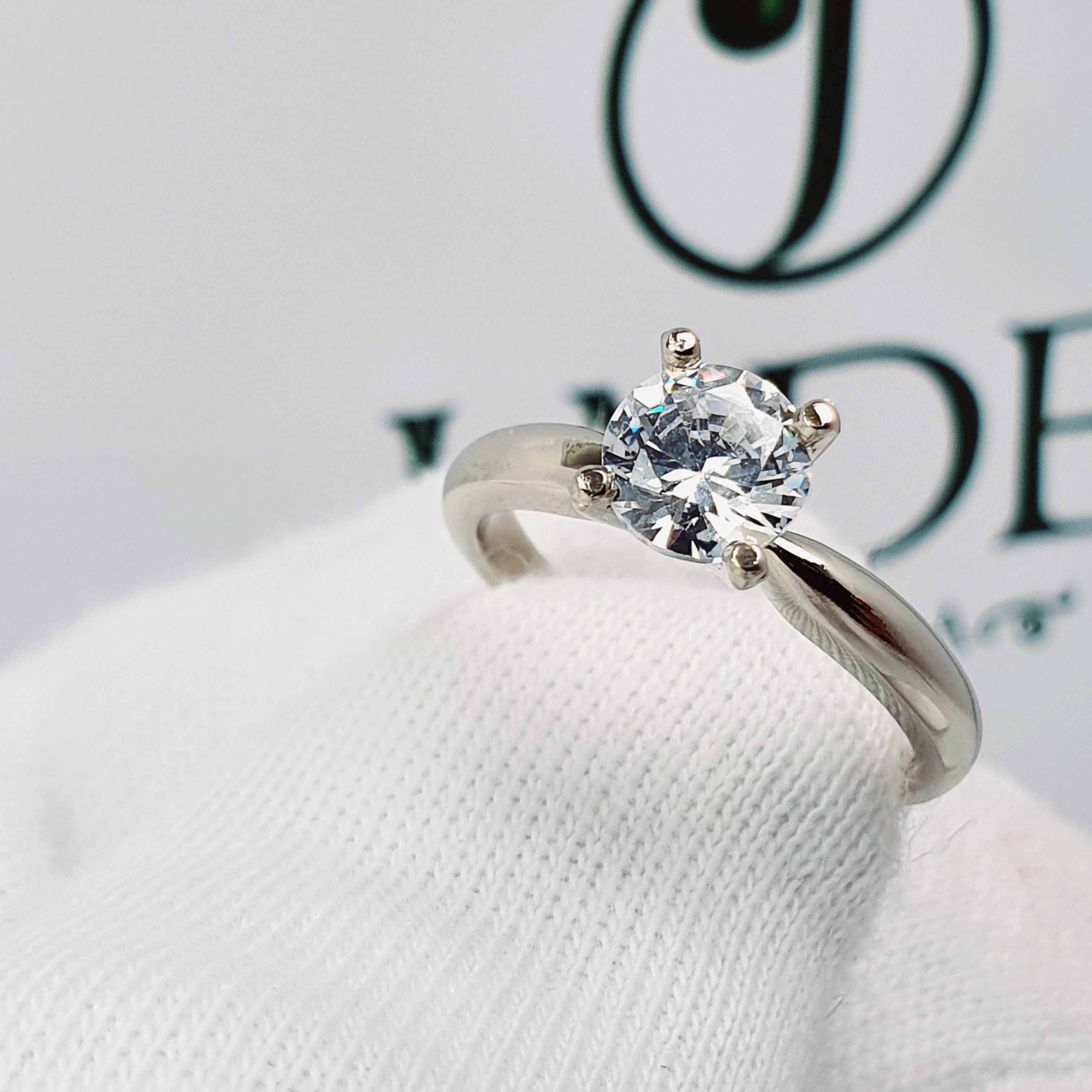 Jade18k 18k white gold solitaire engagement ring with a round brilliant cut diamond.