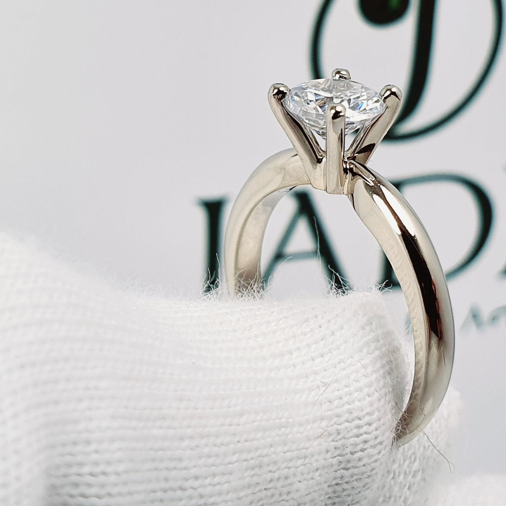 Jade18k 18k white gold solitaire engagement ring with a sparkling round-cut diamond set in a six-prong basket setting.