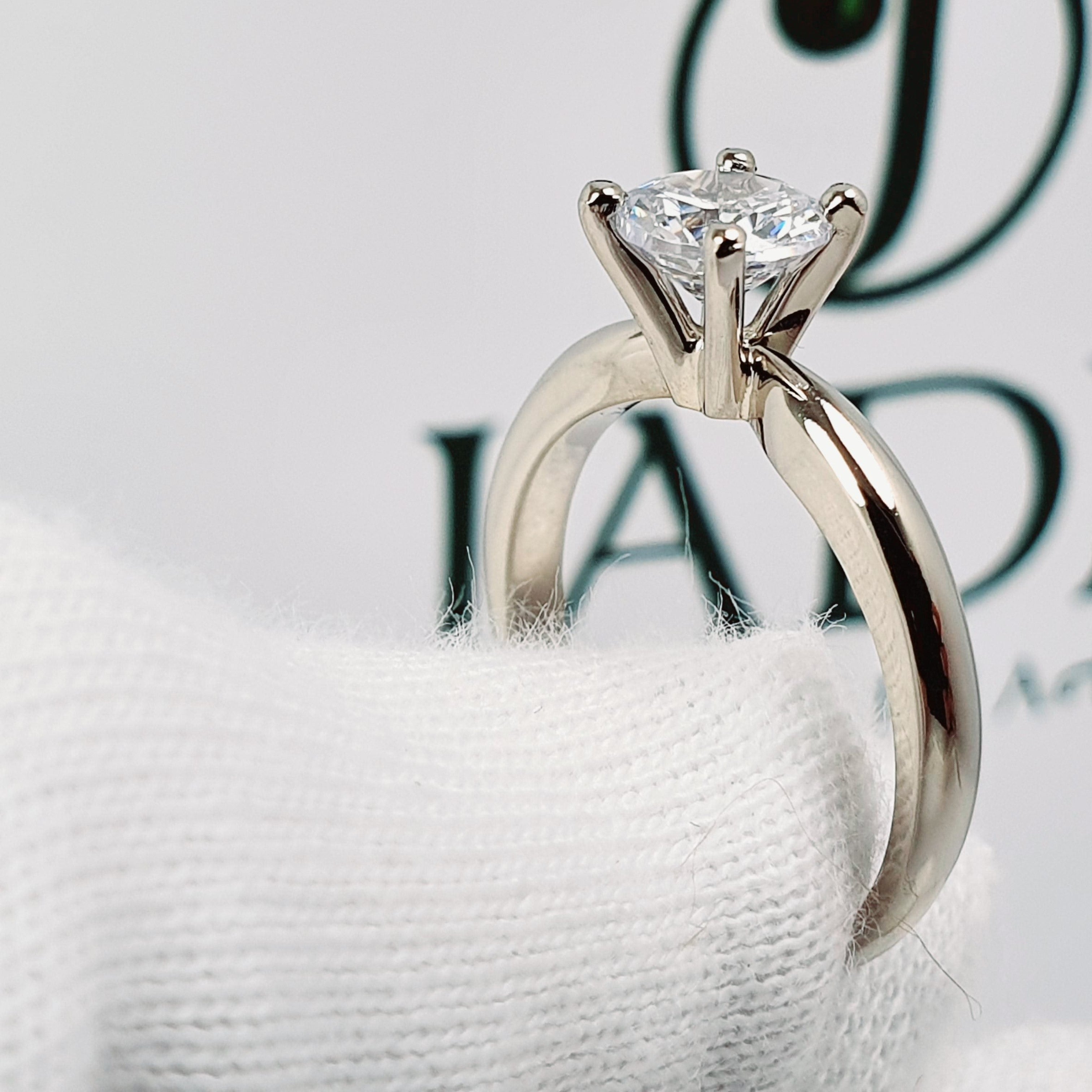 Jade18k 18k white gold solitaire engagement ring with a sparkling round-cut diamond set in a six-prong basket setting.