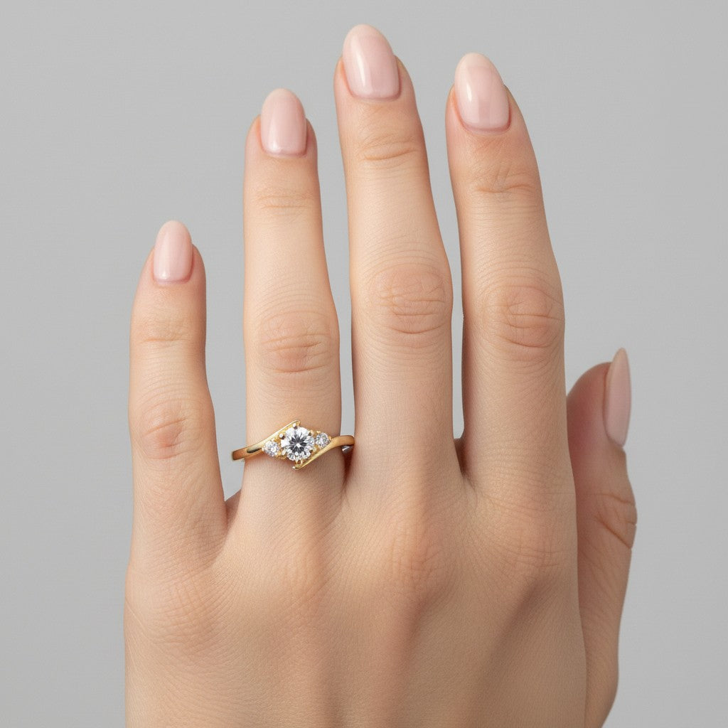 Jade18k 18k yellow gold engagement ring with a central lab-grown diamond and two smaller side diamonds.