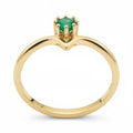 Jade18k yellow gold ring with a small green emerald gemstone set in a V-shaped band.