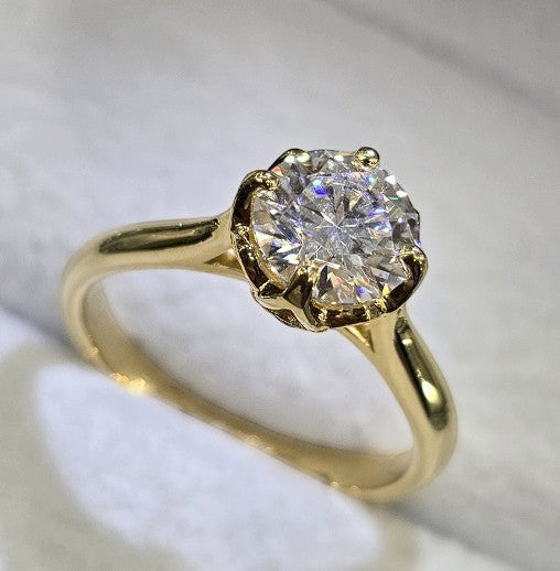 Jade18k 18k yellow gold engagement ring with a round-cut cubic zirconia stone and prong setting.