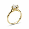 Jade18k 18k yellow gold engagement ring with a large round-cut center stone and floral-inspired setting with small accent stones.
