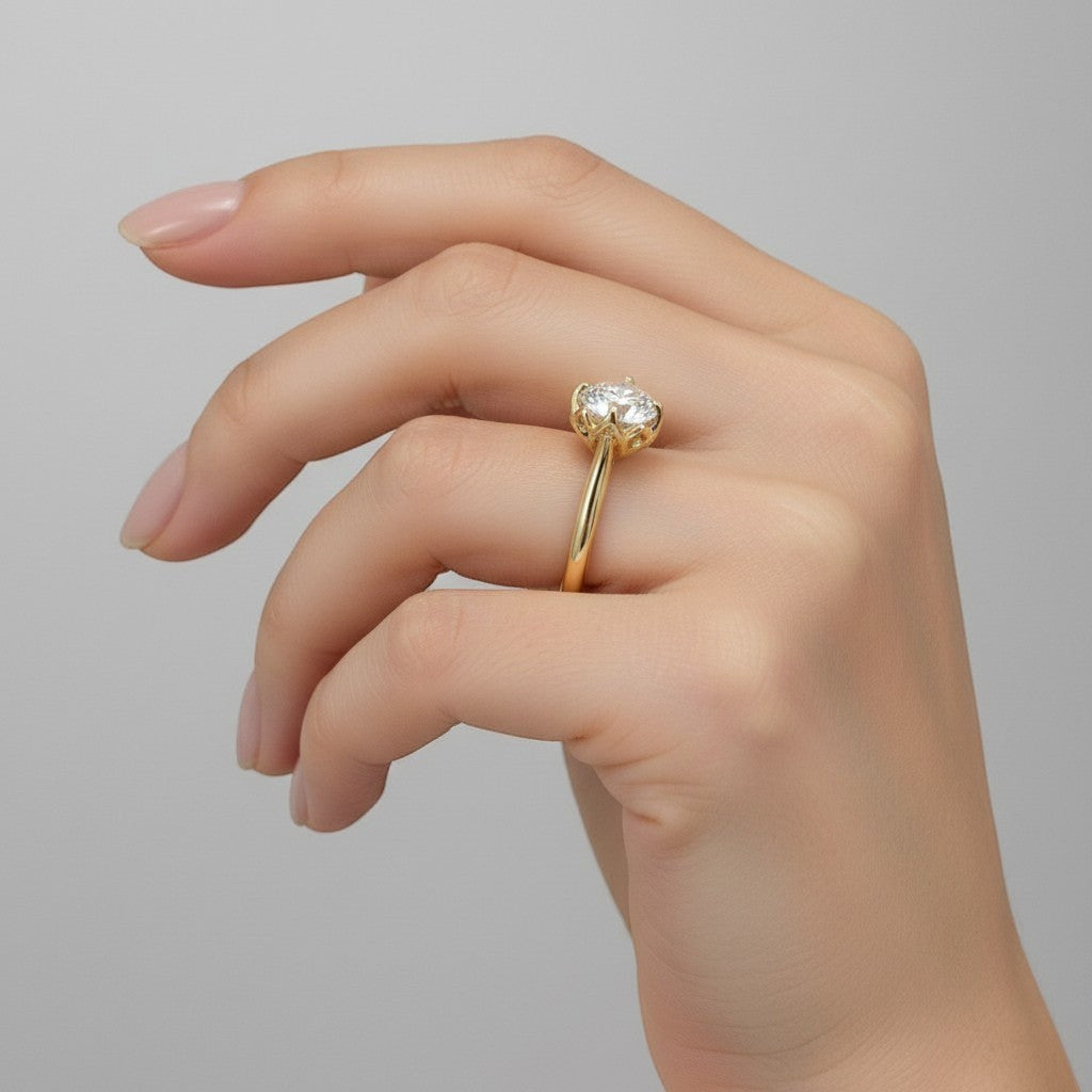Jade18k 18k yellow gold engagement ring with a large round-cut cubic zirconia and small accent stones. Unique floral-inspired setting.
