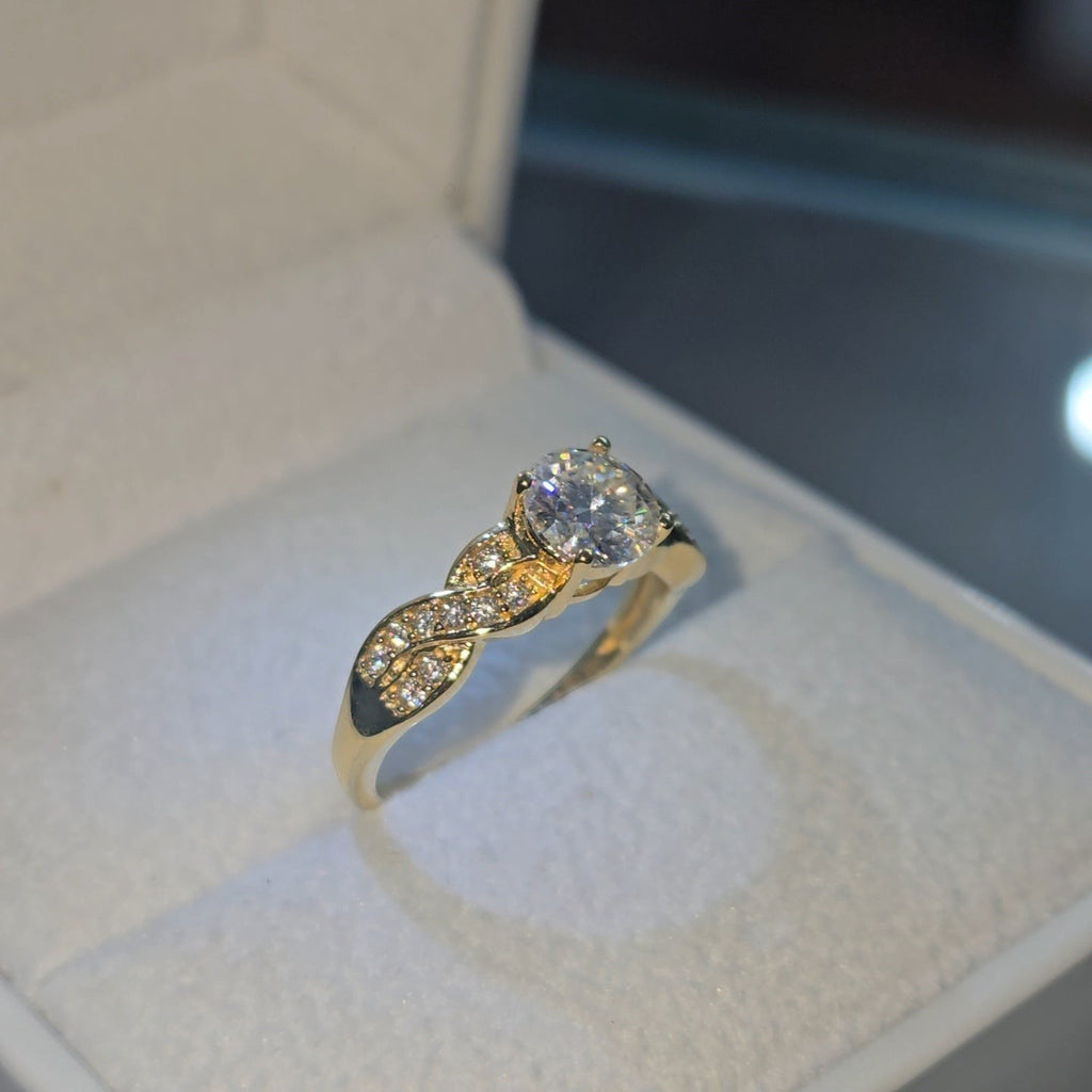 Jade18k 18k yellow gold engagement ring with a single heart-shaped diamond and twisted band with small diamonds.