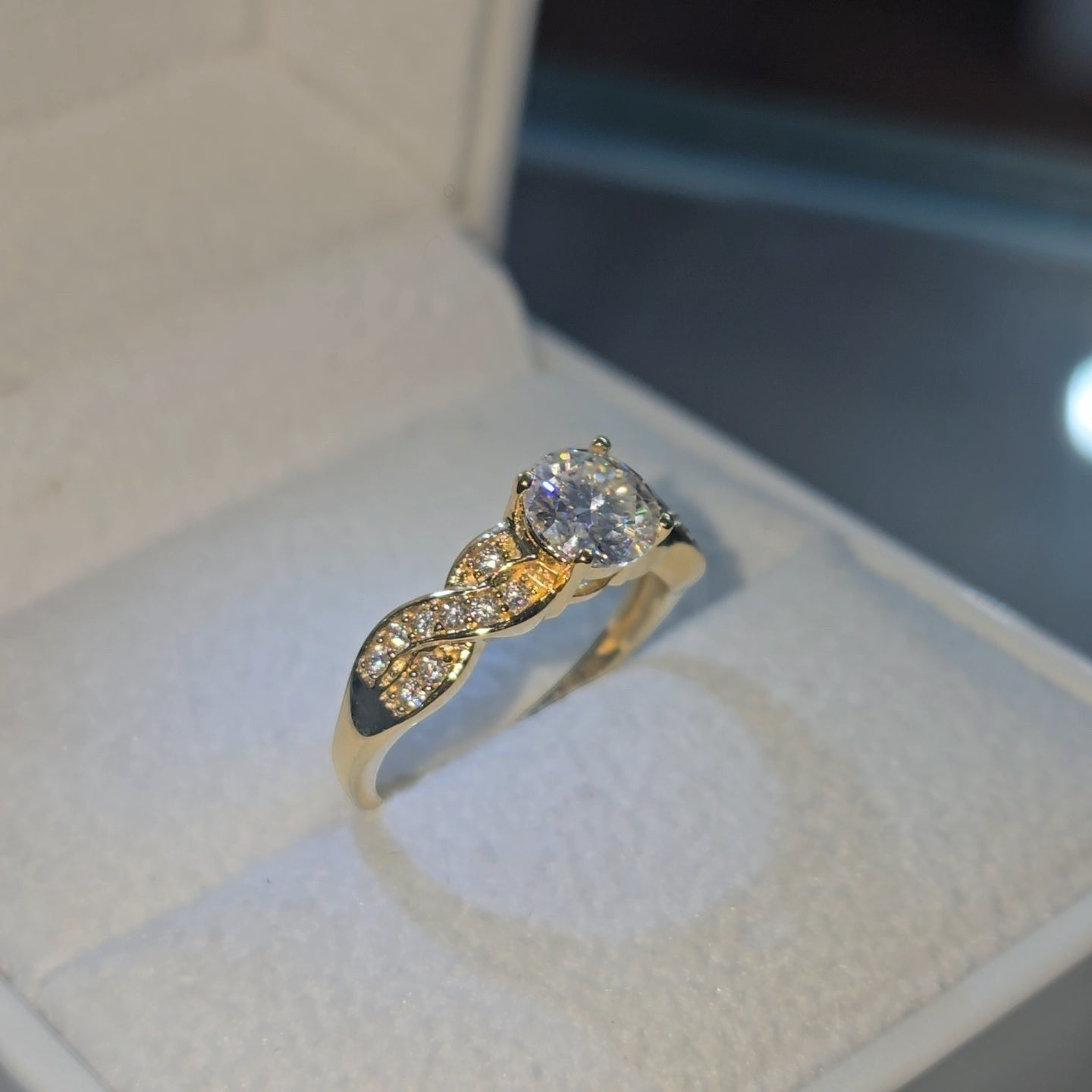 Jade18k 18k yellow gold engagement ring with a single heart-shaped diamond and twisted band with small diamonds.