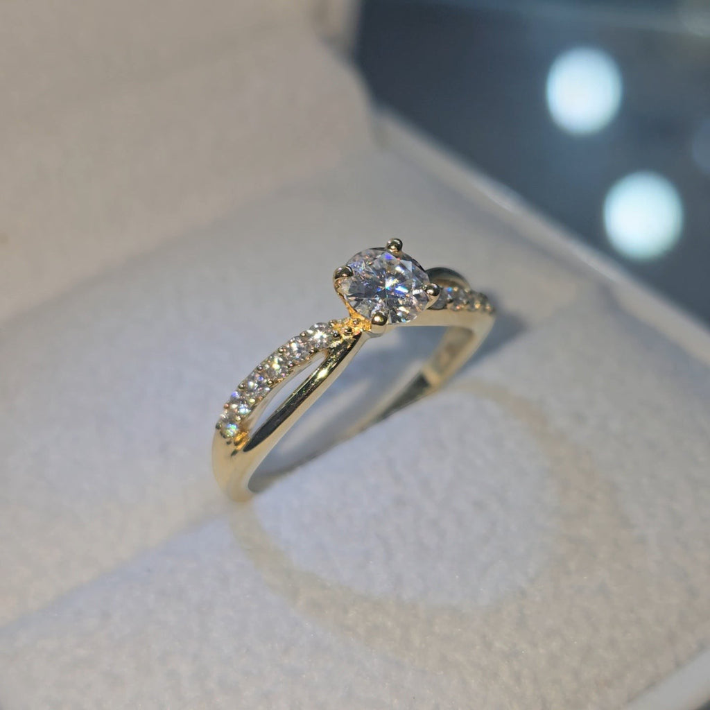 Jade18k 18k yellow gold engagement ring with a central moissanite and a band lined with small diamonds.