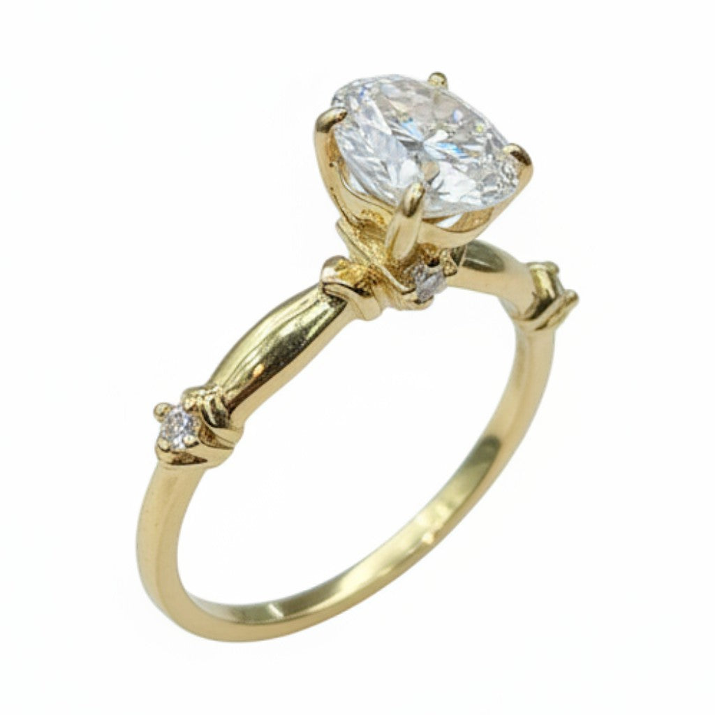 Jade18k 18k yellow gold engagement ring with a large oval moissanite center stone and small accent diamonds on the band.