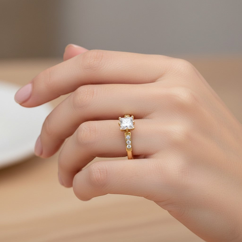 Jade18k 18k yellow gold engagement ring with a princess-cut moissanite center stone and channel-set accent stones.
