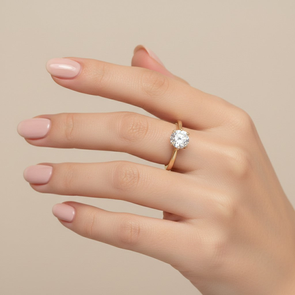 Jade18k engagement ring with a round moissanite stone set in yellow gold. Classic solitaire design.