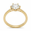 Jade18k yellow gold engagement ring with a round moissanite center stone, six-prong setting.