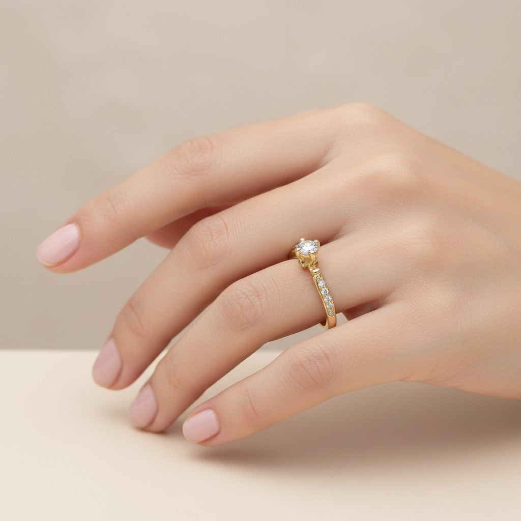 Jade18k 18k yellow gold engagement ring with a central moissanite stone and pavé-set diamonds on the band.