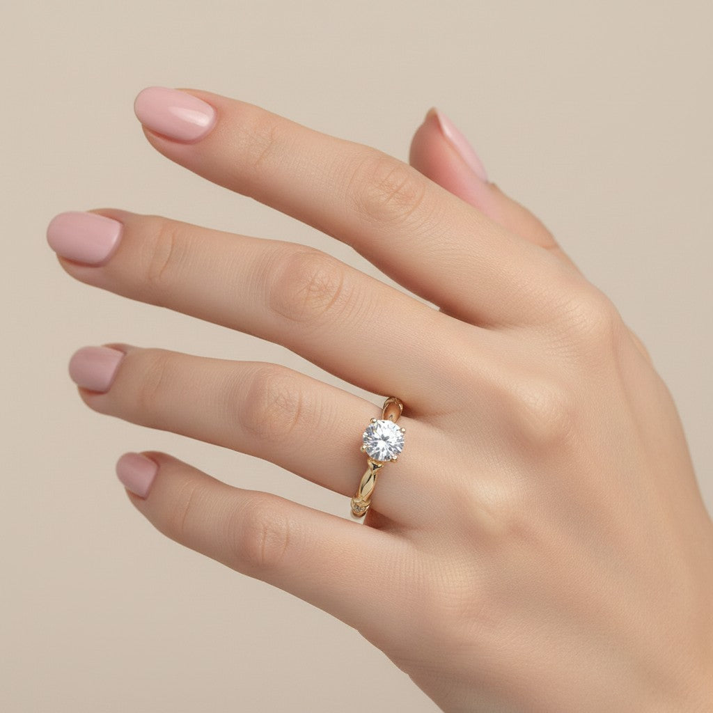 Jade18k 18K yellow gold engagement ring with a central moissanite stone and small accent stones on the band.