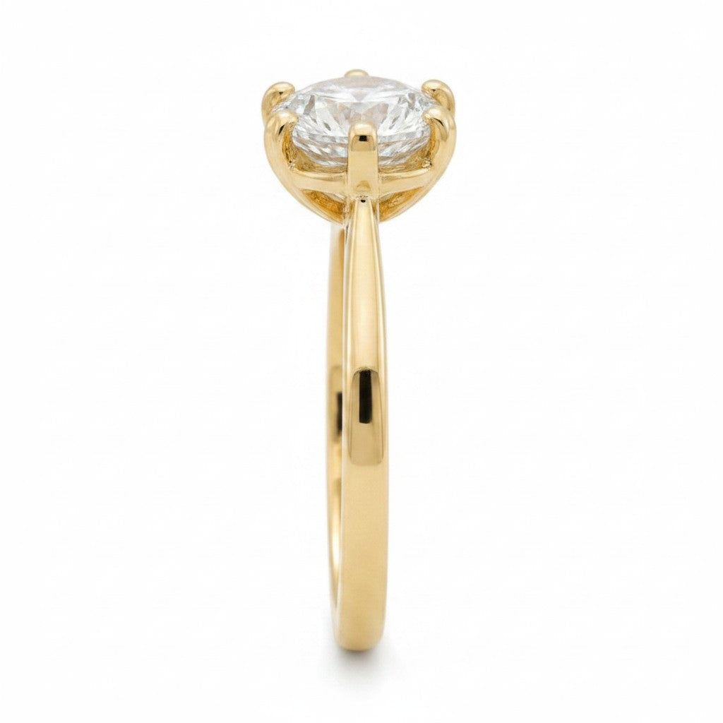 Jade18k 14k yellow gold engagement ring with a round brilliant moissanite center stone and six prongs.