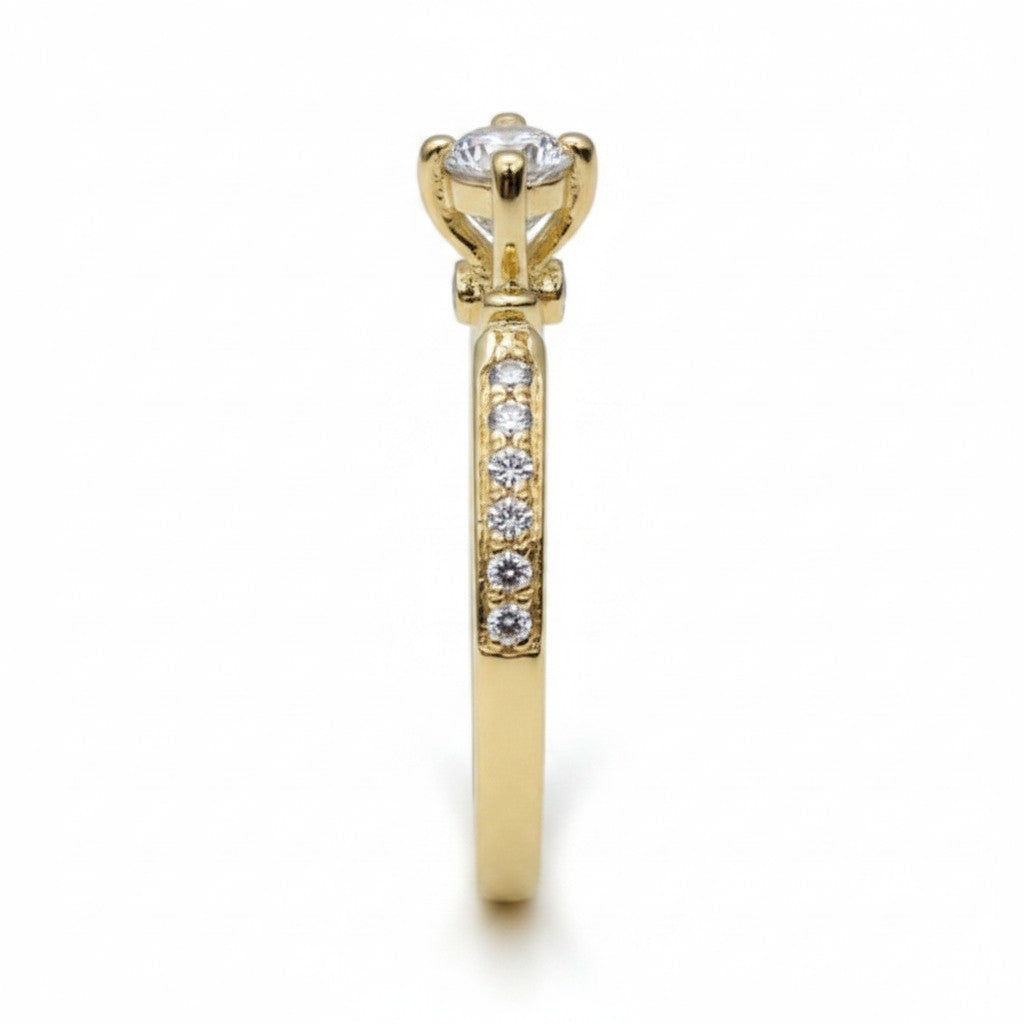 Jade18k 18k yellow gold engagement ring with a central moissanite stone and pavé-set diamonds on the band.