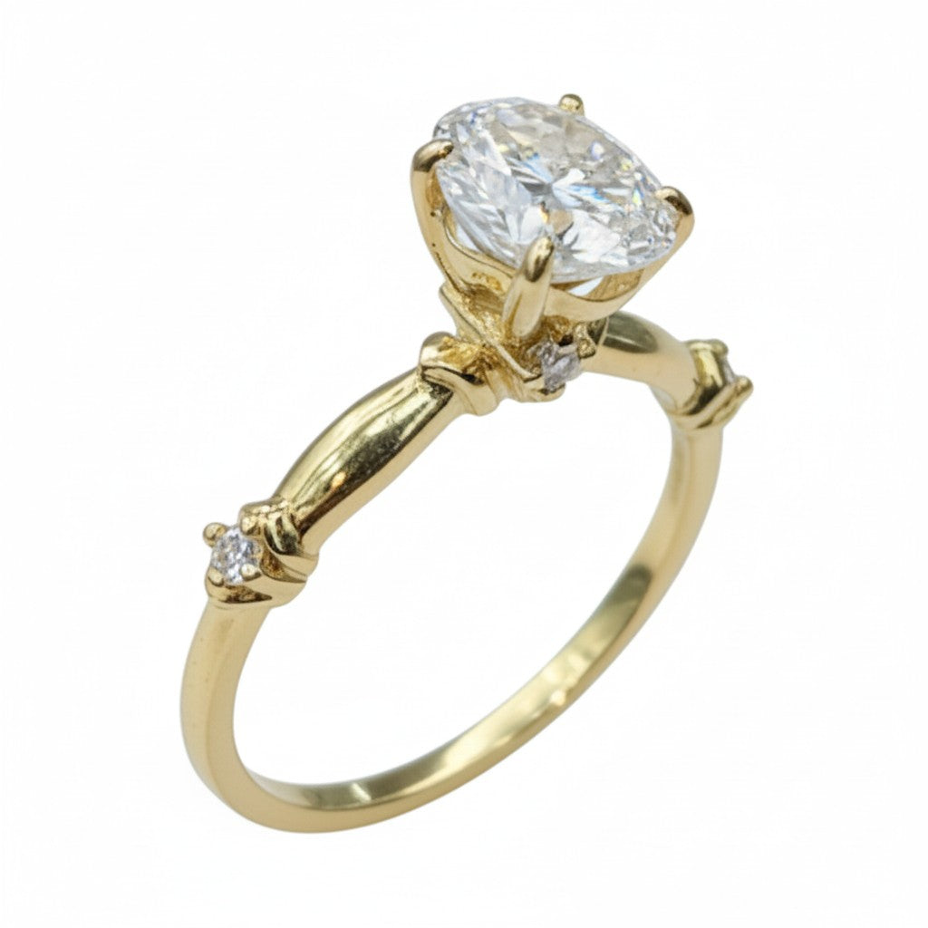 Jade18k 18k yellow gold engagement ring with a large oval moissanite center stone and small accent diamonds on the band.