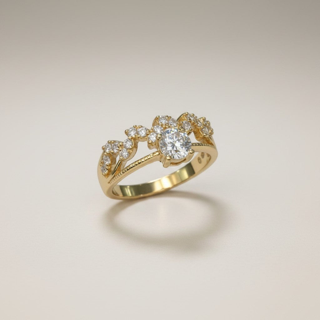 Jade18k 18k yellow gold engagement ring with a central moissanite and smaller stones on a decorative band.