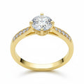 Jade18k 18k yellow gold engagement ring with a round moissanite center stone and pavé band.