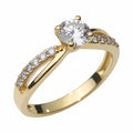 Jade18k 18k yellow gold engagement ring with a central moissanite stone and a band adorned with small diamonds.