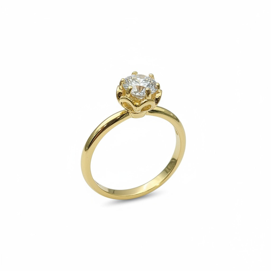 Jade18k engagement ring with a round moissanite stone set in 18k yellow gold with a floral-inspired setting.