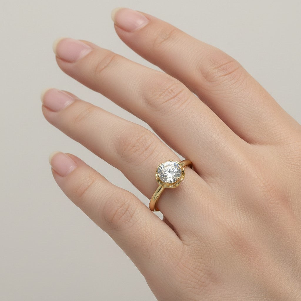 Jade18k 18k yellow gold engagement ring with a round moissanite stone set in a floral-inspired crown.