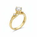 Jade18k yellow gold engagement ring with a central moissanite and two smaller stones on a twisted band.