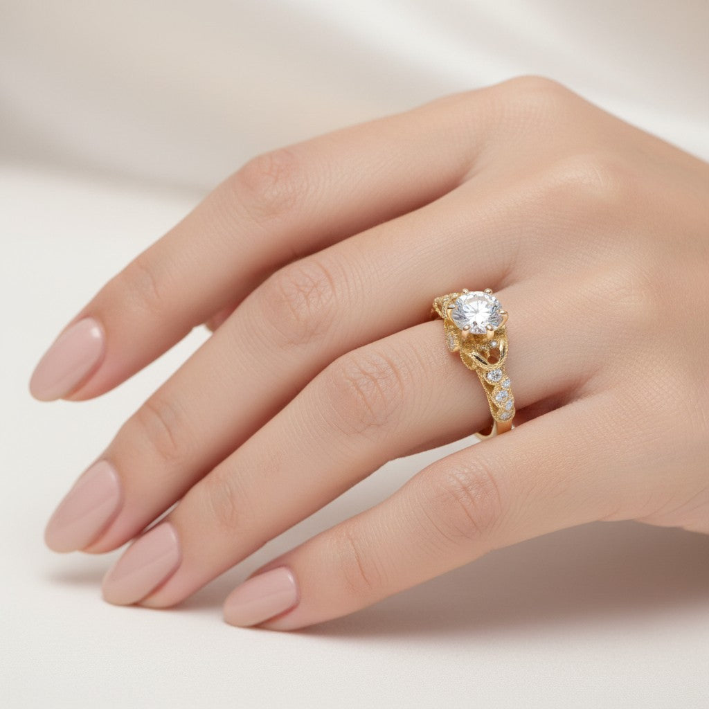 Jade18k 18k yellow gold ring with a central moissanite stone and intricate filigree details, accented with small diamonds.