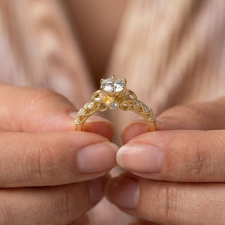 Jade18k ornate 18k yellow gold ring with a central moissanite and smaller stones on the band.