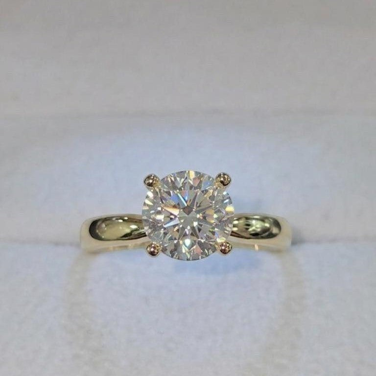 Jade18k 18k yellow gold ring with a large, brilliant moissanite center stone. Classic four-prong setting.