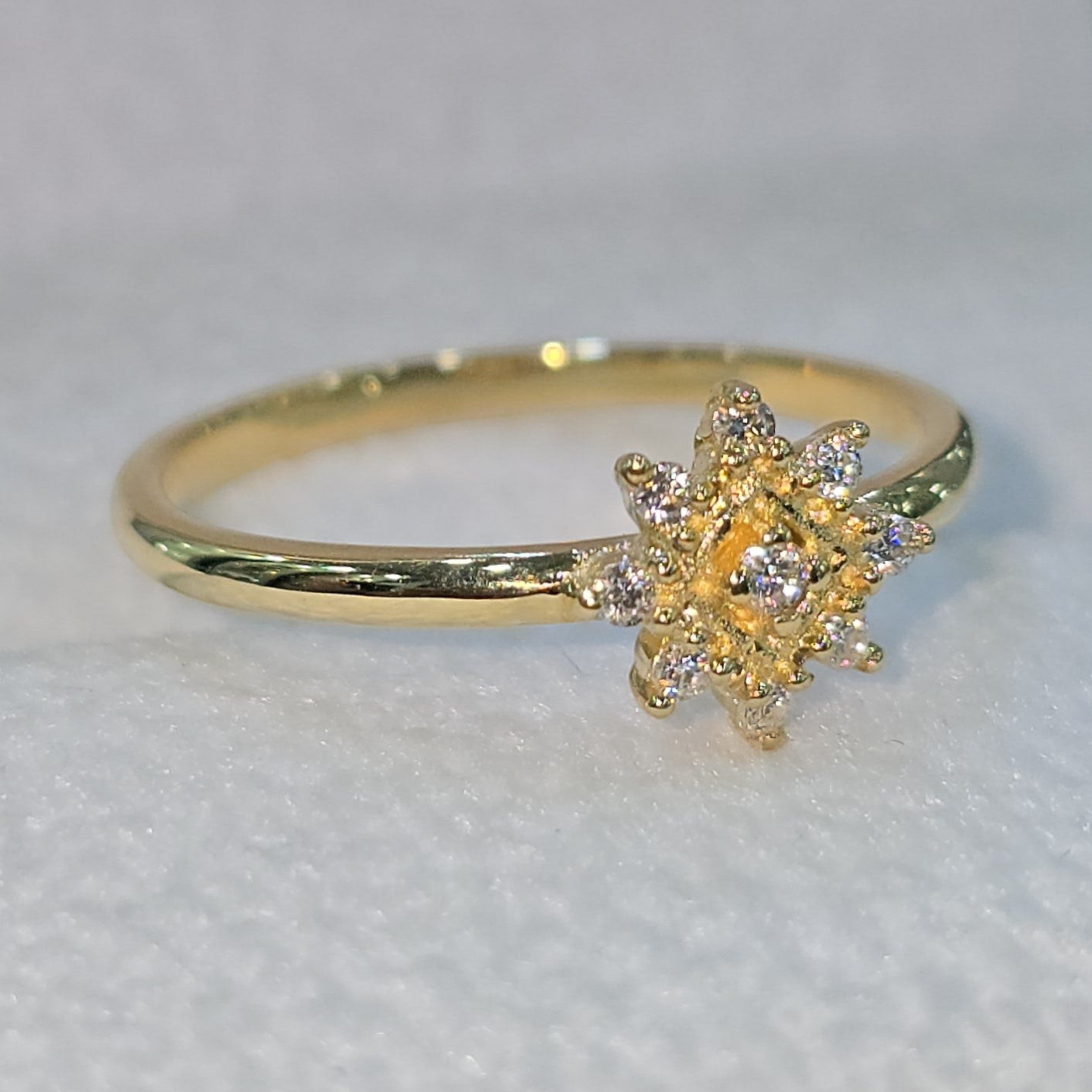 Jade18k yellow gold ring with a starburst moissanite design. 18k yellow gold band.