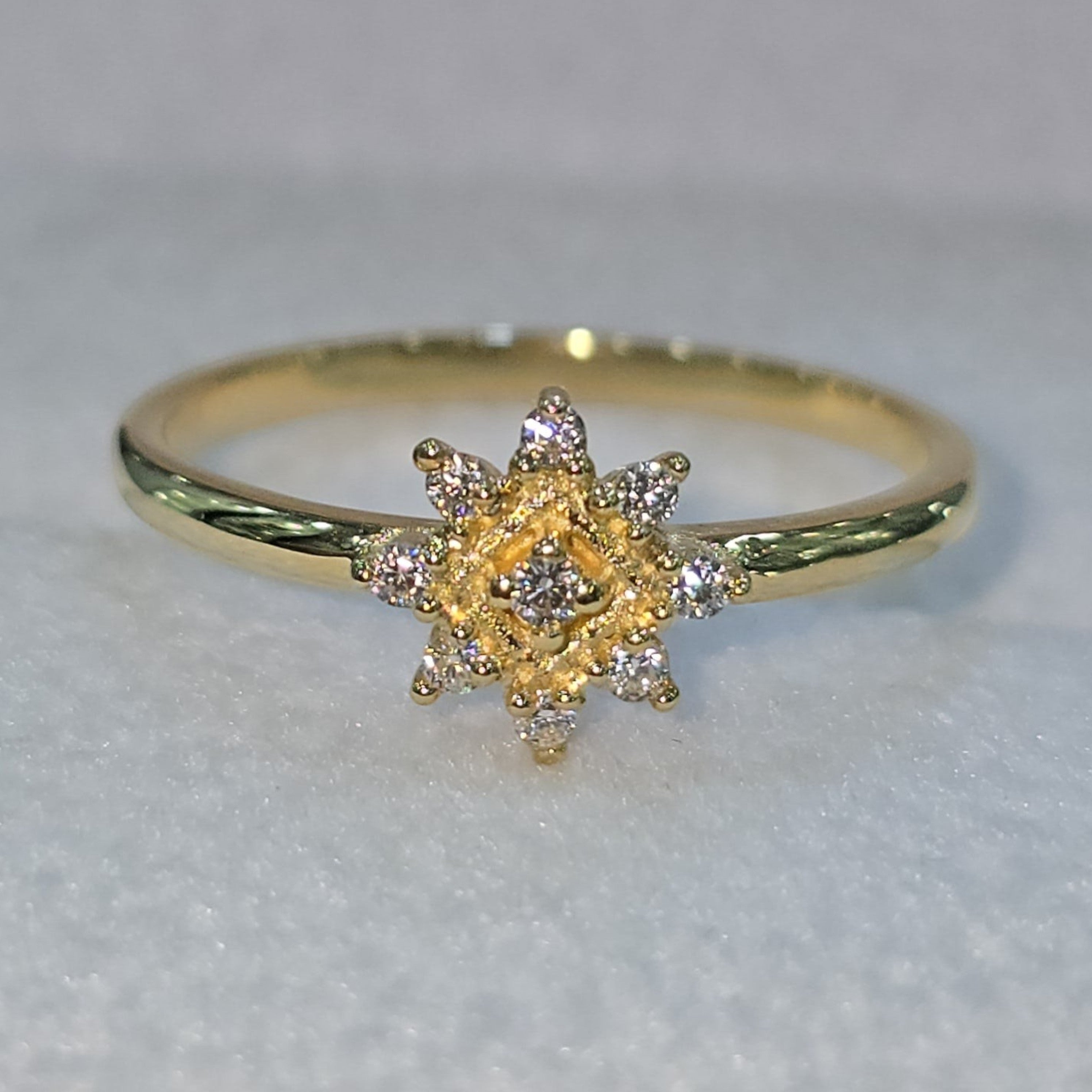 Jade18k 18k yellow gold ring with a starburst design featuring moissanite stones. Delicate and sparkling.