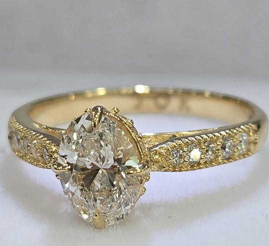 Jade18k 18k yellow gold engagement ring with oval zircon stone and small diamonds on band.