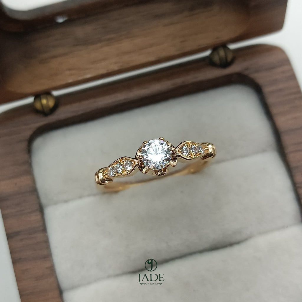 Jade18k Classic Solitaire Engagement Ring in yellow gold with a central diamond and pavé diamond accents on the shoulders.