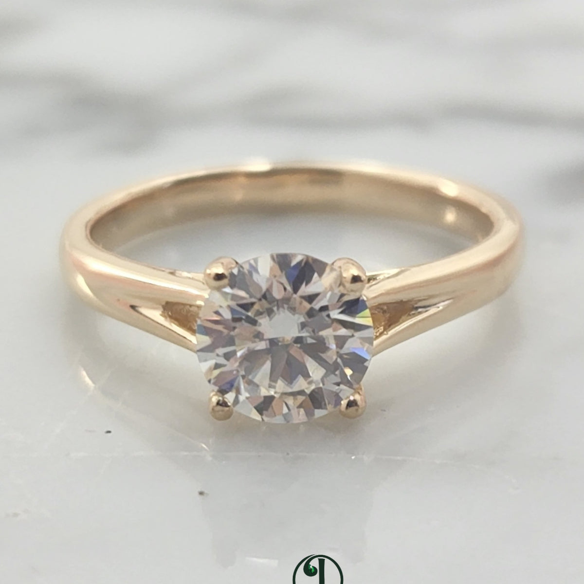 Jade18k 18k yellow gold solitaire engagement ring with a round brilliant cut diamond.