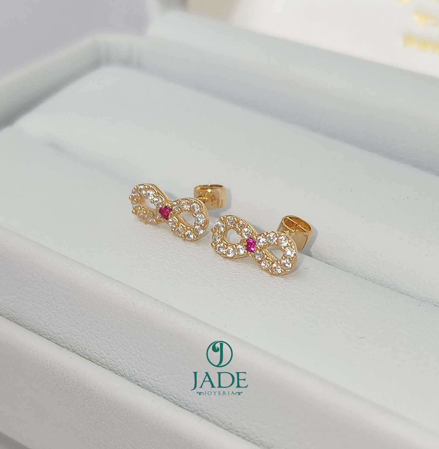 Aretes abridores de moñito en oro 18k