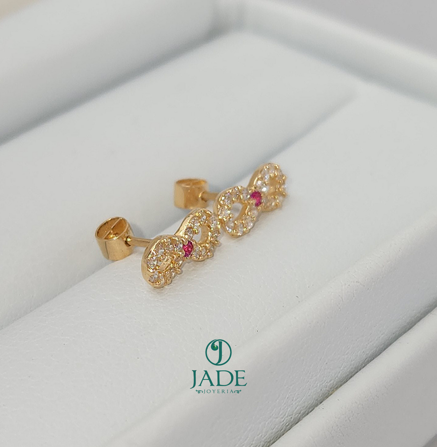 Aretes abridores de moñito en oro 18k