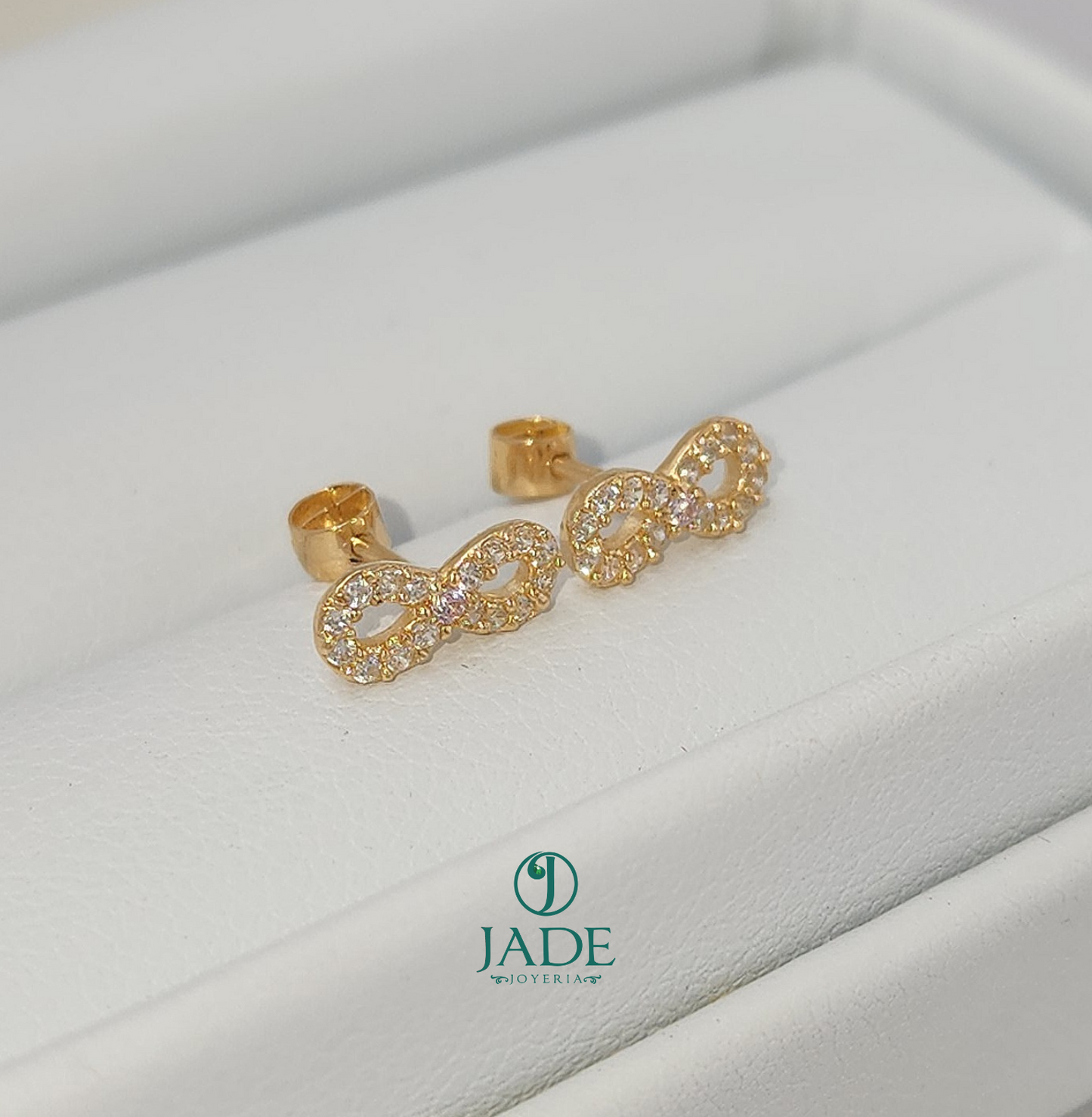 Aretes abridores de moñito en oro 18k