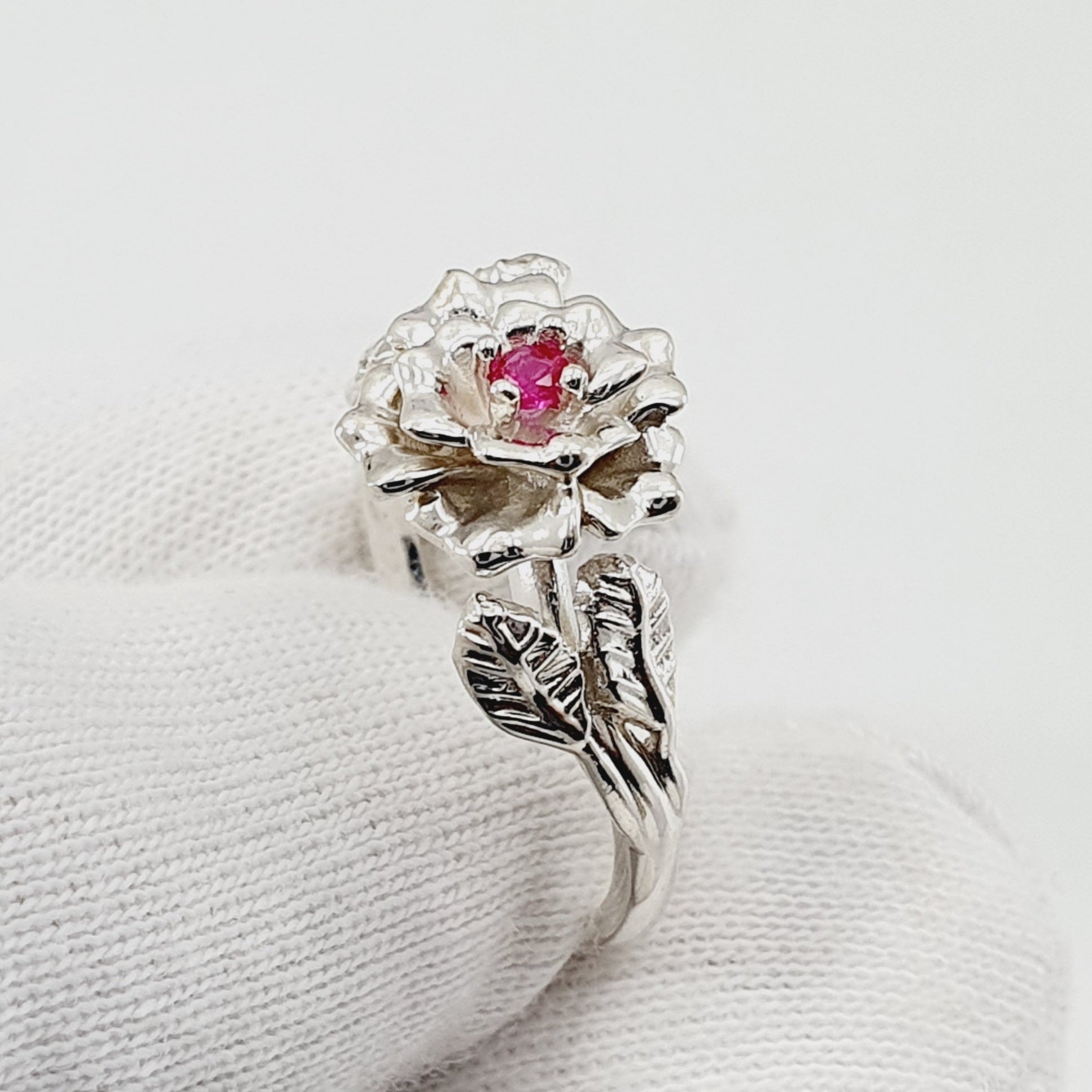 Anillo tipo flor labrada en plata con circon